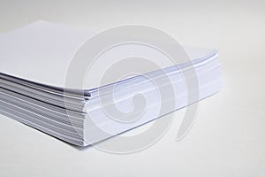 Stack of white paper for printer on gray background