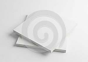Stack of white paper sheets on a clean white background with soft shadows
