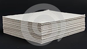 A stack of white paper sheets is displayed against a black background