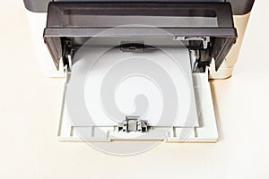 Stack of white paper sheets in printer tray