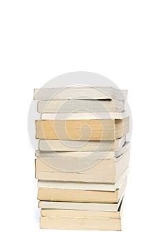 Stack of white paperback books isolated on white with copyspace