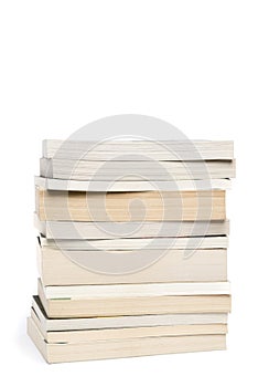 Stack of white paperback books isolated on white with copyspace