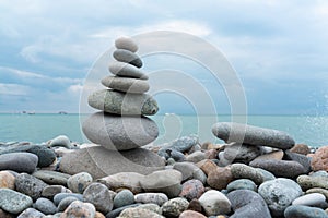 Stack of white pebbles stone against blue sea background for spa, balance, meditation and zen theme