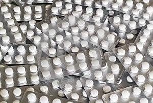 Stack of white pills in blister pack