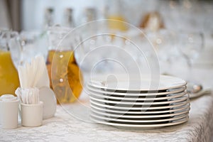 A stack of white plates on the table