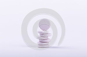 Stack of white round tablets isolated on white background