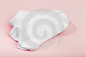 Stack of white socks on pink background