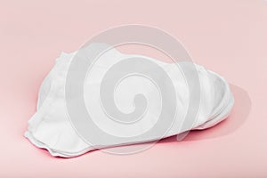 Stack of white socks on pink background