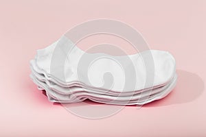 Stack of white socks on pink background
