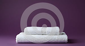 Stack of White Towels on Purple Background for Spa and Bathroom Decor
