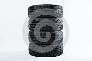 Stack of winter tires with specific structure and deep ridges shot in studio