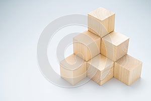 Stack of wood cubes built as step stairs pyramid photo