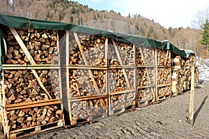 Stack of wood in winter time in an alpine setting.