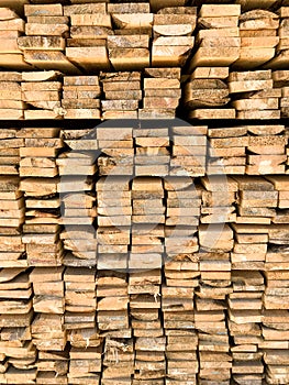 Background of the square ends of the wooden bars. Wood timber construction material for background and texture. close up. Stack o.