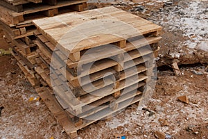 Stack wooden palle at a construction site. Pallets for transportation of goods photo