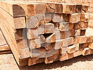 Stack of wooden squared beams background or texture concept