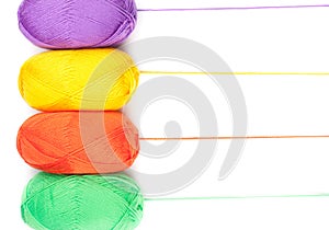 Stack of yarn skeins in yellow, orange, green, purple colors