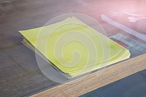 Stack of yellow blank empty paper on table