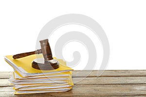 Stack of yellow files with documents and gavel on wooden table against white background. Space for text