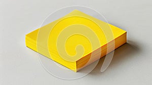 A stack of yellow sticky notes on a light grey surface