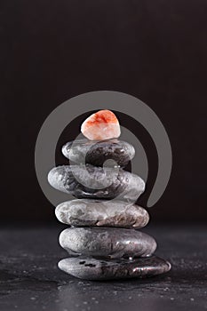 Stack of zen stones concept piled up on black background