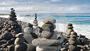 Stack of zen stones over water and blue sky. Shallow depth of field. Canary Islands