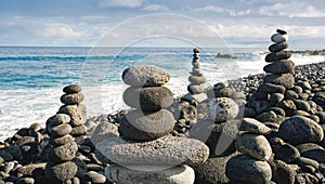 Stack of zen stones over water and blue sky. Shallow depth of field. Canary Islands