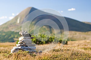 Stack of zen stones overlooking the top of mountain. Concept of