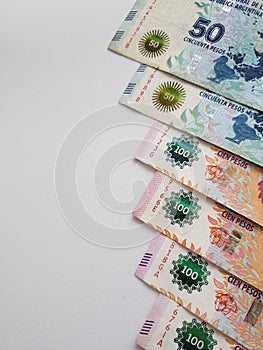stacked argentinean banknotes and white background photo