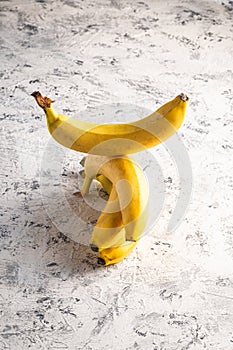 Stacked banana fruits on white textured background