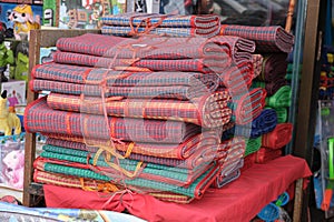 Stacked beach mats on the counter of a street store