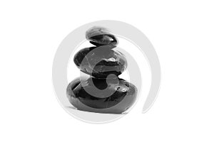 Stacked black stones. Sea pebble. Balancing wet pebbles isolated on white background