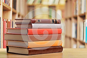 Stacked books on desk at library photo