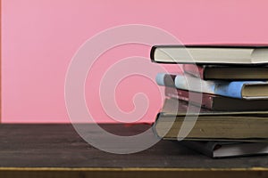 Stacked books on pink background