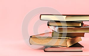 Stacked books on pink background