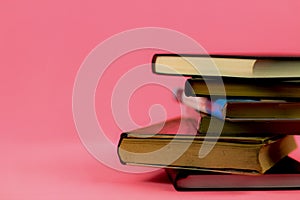 Stacked books on pink background