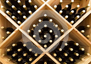 Stacked bottles of grape wine in a wine cellar