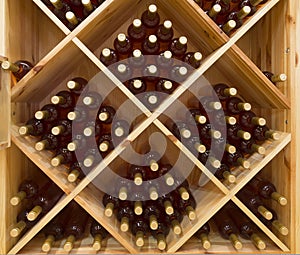 Stacked bottles of grape wine in a wine cellar