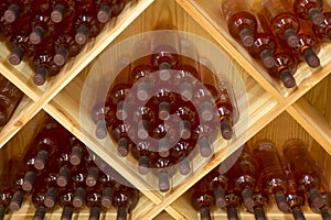 Stacked bottles of grape wine in a wine cellar
