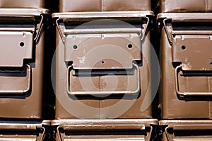 Stacked brown ammunition boxes