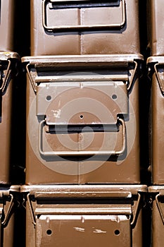 Stacked brown ammunition boxes