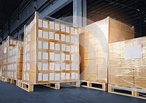 Stacked of cardboard boxes wrapped plastic film on pallet rack. shipment boxes. cargo export. warehouse storage.