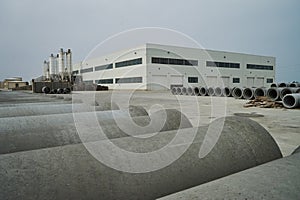 Stacked cement pipes at concrete factory