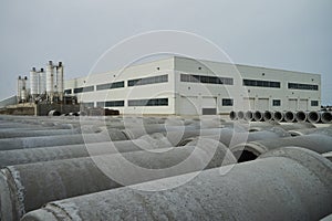 Stacked cement pipes at concrete factory