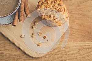 Stacked chip cookies with nuts and coffee cup/ stacked chip cookies with nuts and coffee cup on a wooden table. Top view and