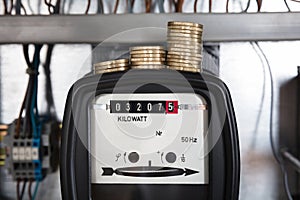 Stacked Coin On Kilowatt Meter