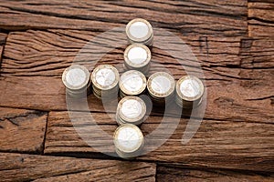 Stacked Coins Forming Plus Sign