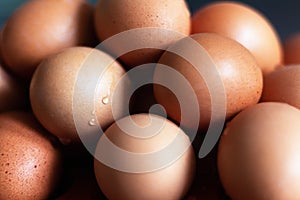 Stacked colored eggs sprayed with water in close up