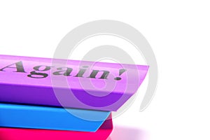 Stacked colorful erasers on a white background with text space. Printed word again on top eraser