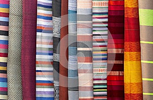 stacked colorful fabrics in the Grand Bazaar in marrakesc, Marocco